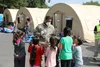 Soldiers from 21st Theater Sustainment Command provide security and assistance to Afghan evacuees at the transit area known as pod 51 on Ramstein Air Base September 9, 2021. The transit cente