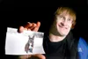 ROBERT DeBERRY/Frontiersman Jack Runser holds a picture of his
dog Sheba.