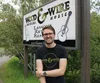 Todd Farnsworth stands in front of the sign at the new location of Wood and Wire Guitars and Music. Jacob Mann/Frontiersman