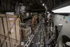 A U.S. Air Force C-17 Globemaster III aircraft loadmaster, assigned to the 816th Expeditionary Airlift Squadron, ensures the cargo is secured properly during a mission in support of Combined 