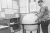 (Photo courtesy George Carte) George Carte using a 36-inch globe
to locate an earthquake in 1969 at the Palmer observatory.