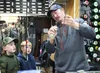 A.J. Hoffman shows young anglers Wiley Walsh, left, and Huey Walsh, middle, how to set up a bobber rig for fishing in local Mat-Su Valley lakes. The Walsh family stopped by the shop for fishi