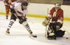 Houston junior forward Wade Williams slips a backhand shot past
Wasilla goaltender Ronnie Walker during the second period of the
Hawks' 4-3 win over the Warriors on Wednesday. Photo by JEREMI