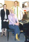 Sarah Hendricks, left, and Cambria Moss, standing, were selected
for national choirs. Their voice coach, Janet Stotts, sitting, also
attended the American Choral Directors Association nationa