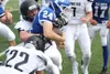 A pair of Juneau players tackle Palmer's Jayden Christiansen during a Moose win over Juneau Aug. 11 in Palmer. Juneau, a new co-op team, still has no nickname. Jeremiah Bartz/Frontiersman