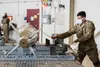 U.S. Air Force Airman 1st Class Aaron Aguilar, 90th Maintenance Unit weapons crew member, tightens the straps on a GBU-32 Joint Direct Attack Munition during the 2nd Quarterly Wing Load Crew 