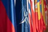 The North Atlantic Treaty Organization flag hangs alongside the flag of the Republic of Slovenia in the plenary room at NATO Military Committee Conference in Ljubljana, Slovenia, Sept. 13, 20
