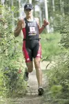 ROBERT DeBERRY/Frontiersman Tri the Trails first-place women's
finisher Amber Stull enters the woods during Saturday’s triathlon
at Matanuska Lakes State Recreation Area. Robert DeBerry