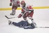 Soldotna Star Jarrett Urban goes down in front of Warrior
defenseman Chancie Hanson during Friday's semi-final match at the
Region III Northstar Conference Hockey Championships at the MTA
Pal