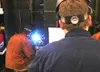 A judge stands behind a determined welding student, watching his
every move. BOB MARTINSON/Frontiersman