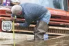 Angelo Wright checks the water height at his cousin's house Saturday morning in Houston. Wright said the water level had dropped about 11 inches in about an hours time. ROBERT DeBERRY/Frontie