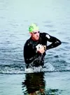 Jens Beck emerges from the water after the 900-meter swim in the
Big Lake Triathlon Sunday. Beck and the field of athletes biked,
ran and swam their way to the finish line. Beck won the event