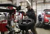 A Diversified Tire employee changes studded tires for a customer in this Frontiersman file photo. Frontiersman file photo