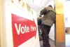 ROBERT DeBERRY/Frontiersman Voters wanting to cast an early
ballot wait in the hallway at the North fork Professional Building
polling location in Wasilla Monday afternoon.