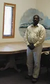 Donell Polk, lead resident adviser at the Saxton Youth Shelter,
shows off the shelter's new dining room table. A grant is allowing
the shelter to replace some of its furnishings and make upgr