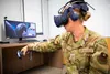 Air Force Staff Sgt. Renee Scherf, Detachment 23 curriculum engineer, MC-130H subject matter expert, demonstrates a virtual reality training system. Members of Detachment 23’s Tech Training T