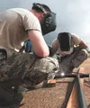 Airman 1st Class Phillip Gifford, left, and Tech. Sgt. Mark Hill of the Alaska Air National Guard’s 176th Civil Engineer Squadron weld a safety railing here May 6. Thirty-four Alaska Air Guar