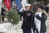 Marine Corps Maj. Mike Sickels salutes a wreath he placed with Gold Star family member Anne Kitchens, during the annual Wreaths Across America day at the Fort Richardson National Cemetery at 