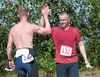 Dave Whitfield and John Page high-five after completing the Why Not Tri triathlon Saturday at Wasilla High School. ROBERT DeBERRY/Frontiersman.com