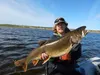 Kurt Heim shows a lake trout he caught in the Fish Creek watershed on the Arctic Coastal Plain. (Lydia Smith)