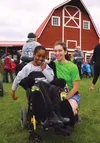 Mat-Su Career and Technical High School graduate Allison Qualls smiles for a photo with friend Eric Edwards after the 2016 ‘Running with the Bulls’ at The Musk Ox Farm in Palmer on Sunday. Qu