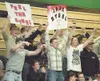 Spectators at Thursday’s wrestling showdown come to their feet
and wave signs as wrestler Jaxx Steel enters the ring. ROBERT
DeBERRY/Frontiersman