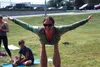 Hilary Rowbotham balances on  the feet of a visiting AcroYoga instructor July 14 as part of Yoga in the Park, sponsored by Anjali Yoga Room from noon to 1 p.m., Tuesdays at Nunley Park in Was