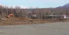 An excavator sits idle Monday afternoon at the future site of a new Palmer Fred Meyer store at the corner of the Glenn and Palmer-Wasilla highways. Land clearing has begun at the site, which 