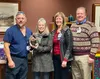Kerston Krull, RN, BSN, shows off the 2022 Nursing Excellence Award crystal plaque she received. Medical-Surgical Director Eric Moreno, CNO Shari Giese and CEO Dave Wallace surprised Krull wi