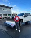 Kaedyn Jennings stands in front of an official Snip&amp;Clip Lawn Care vehicle equipped with a snow plow. Courtesy photo