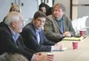 FEMA Director Craig Fugate, left, Sen. Mark Begich, second left, Mat-Su Borough Assemblyman Steve Colligan, right, and a number of other borough and city of Palmer officials discuss disaster 