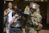 Private 2nd Class (ret.) Warren H. Schuster holds a M249 Light Machine Gun during a visit to 2nd Battalion, 35th Infantry Regiment, 3rd Infantry Brigade Combat Team, 25th Infantry Division, o