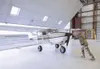 Sgt. 1st Class Robert Masterman, an Alaska National Guard recruiter, pushes his plane out of the hangar. Masterman recruits future Soldiers in several villages scattered across a 50,000-squar