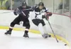 Robert DeBerry/Frontiersman Houston forward Cody Lipse attempts
to check Colony’s Morgan McJimsey into the corner during Friday’s
game at the Curtis C. Menard II Memorial Ice Arena in Wasilla