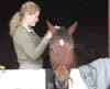 ROBERT DeBERRY/Frontiersman Britany Kaiser braids the mane of
her horse Dakota Thursday at the Hunter Jumper Horse Show at the
Alaska State Fairgrounds.