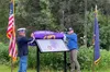 John Knott, former Alaska commander of the Military Order of the Purple Heart, and former Alaska State Sen. Josh Revak unveil a new Purple Heart Trail information marker Aug. 7 at the veteran