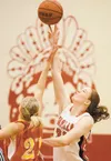 Wasilla forward Kyla Dinkel out-jumps West Valley’s Hannah Mattson during Saturday’s game on the final day of Doc Larson’s Roundball Classic. ROBERT DeBERRY/Frontiersman.com