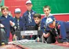 A pack of Cub Scouts watch with anticipation as their pinewood derby cars roll from the starting gate and race toward the finish line during the Pinewood Derby at last year’s Scout-O-Rama at 