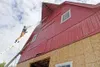 ROBERT DeBERRY/Frontiersman Volunteer Jeff Chabot power washes
old paint off the Breeden Barn at the Alaska Musem of
Transportation and Industry. The barn was moved from the Breeden
farm in A