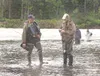 HANNAH GUILLAUME/Frontiersman Alaska Wildlife Trooper Doug
Massie, left, asks Sam Booth, 24, of Salt Lake City for his fishing
license and king salmon stamp at the Clear Creek confluence with