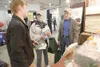 ROBERT DeBERRY/Frontiersman Palmer residents Michael and Phyllis
Kircher talk with Kevin Wirtanen at the Polyseal booth at the
Mat-Su Home Builders Association Home Show Saturday at Raven Hal