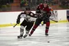 Kenai River's Emil Ezitis and Tanner Schachle of the Fairbanks Ice Dogs battle for a puck earlier in the 2017-18 season. The North American Hockey League Junior A hockey teams will face off F