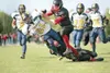 ROBERT DeBERRY/Frontiersman Houston’s Zackary Qual and Brandon
Dukes take down Homer Mariner Jeremiah Carr during the final
minutes of the first half of Saturday’s game at Houston High
School