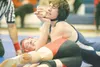 ROBERT DeBERRY/Frontiersman Houston grappler Garrett Elder
pushes on the chin of Palmer wrestler Jared Kemp during a match in
the 130-pound class during a dual at Palmer High School on
Thursd