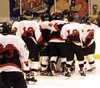 Houston players swarm goaltender Matt Dischner in celebration
after the final buzzer of Saturday's 7-2 championship victory over
Delta Junction. Photo by TIM BRODT/Frontiersman.