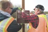 Wasilla city employees Jeremy Peterson and Lynn Follett erect a
sign at the start of the Wasilla Iditarod Walkabout at Tanaina
Elementary. This point represents Seward, and the trail ends at 