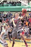 Wasilla’s Dane Kuiper goes for two points during the Warriors’
win over the Colony Knights Tuesday at Colony High School. Kuiper
brought fans to their feet in the second half with a pair of s