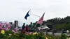 Betty Vehrs and Craig Stewart wave flags as residents gathered to sign a petition to recall Gov.Mike Dunleavy Tim Rockey/Frontiersman