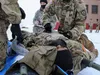 Paratroopers with the 4th Infantry Brigade Combat Team (Airborne), 25th Infantry Division, “Spartan Brigade,” prepare a simulated casualty from movement in Arctic conditions during the inaugu