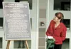 State Sen. Linda Menard reads the inscription on a plaque
dedicated to the the memory of her husband, Curtis D. Menard. The
plaque is at the Curtis D. Menard Memorial Sports Center in
Wasilla